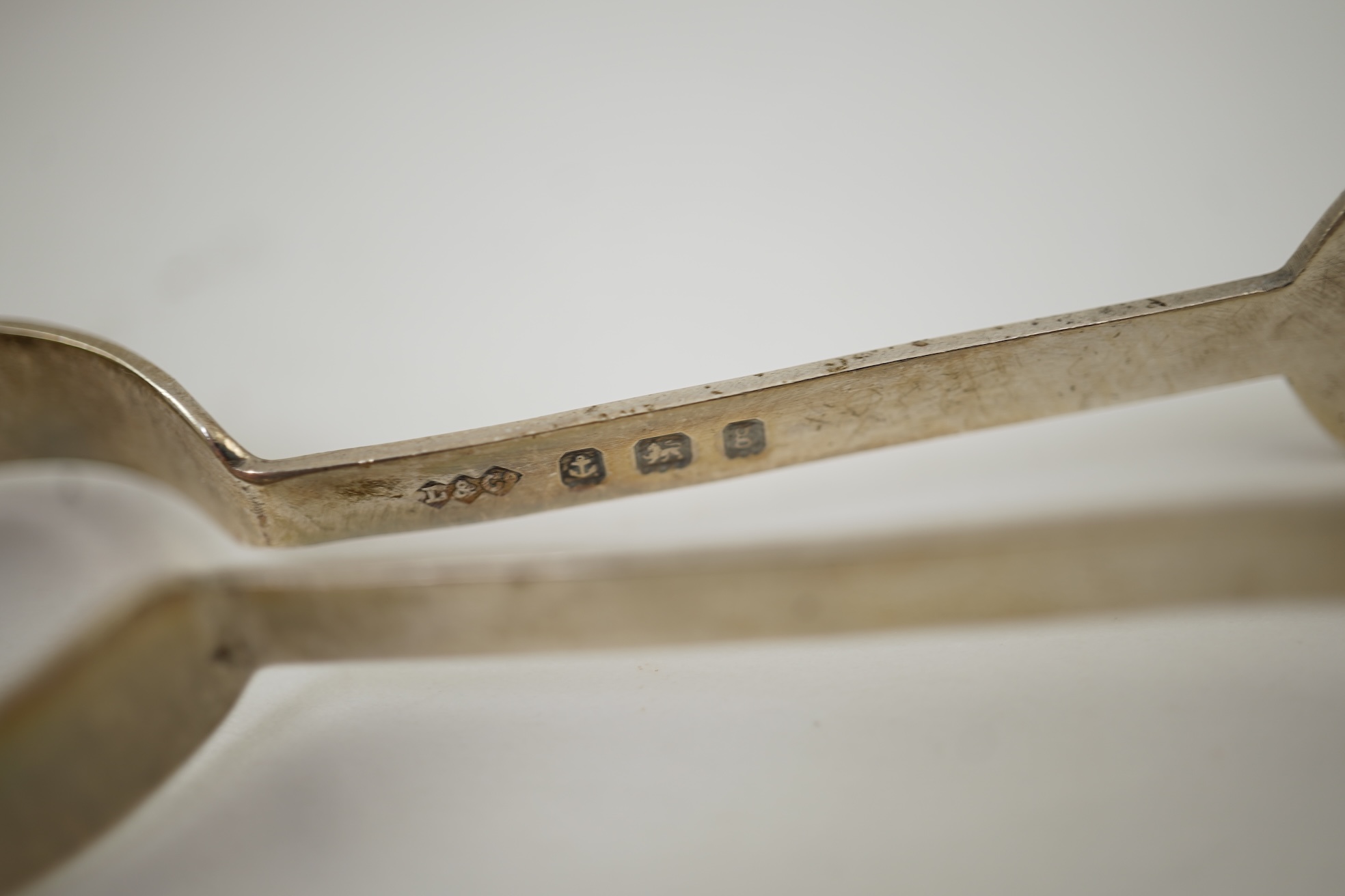 An Edwardian silver bachelor's two handled sugar bowl and matching sugar tongs, by Liberty & Co